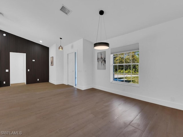 interior space featuring hardwood / wood-style flooring and wooden walls