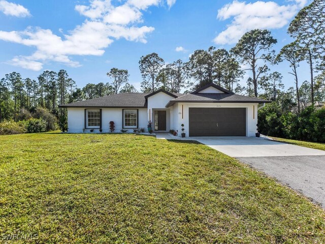 ranch-style house featuring a garage and a front lawn