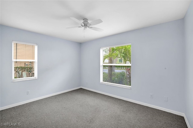 spare room with ceiling fan and carpet