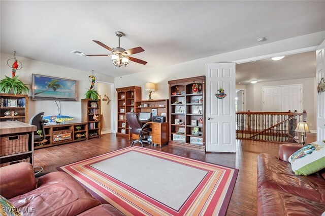 living room featuring ceiling fan and dark hardwood / wood-style flooring