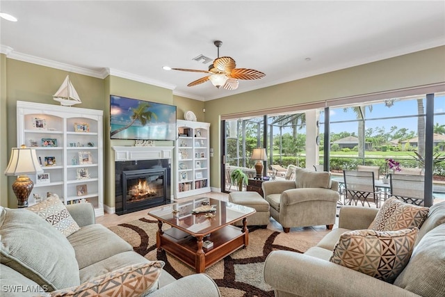 living room with ceiling fan and crown molding