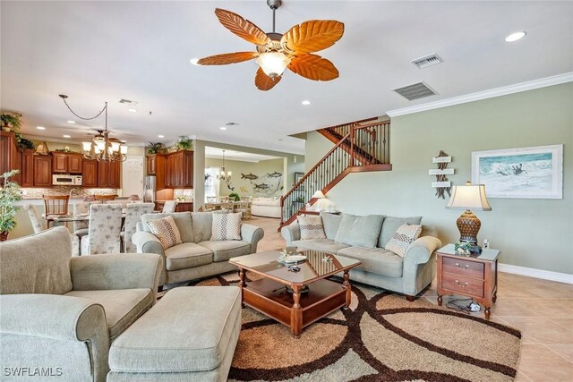 living room featuring ceiling fan with notable chandelier, light tile patterned floors, and crown molding