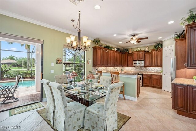 tiled dining area featuring ceiling fan with notable chandelier and crown molding