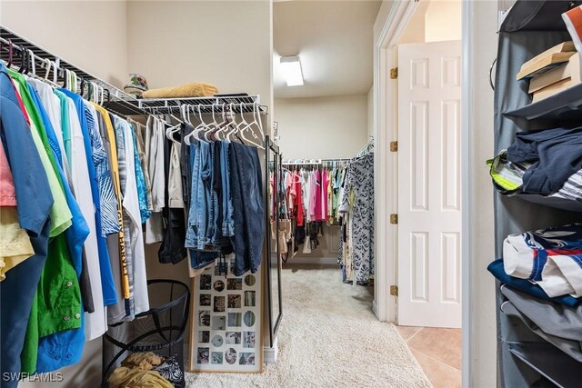 walk in closet with light tile patterned floors