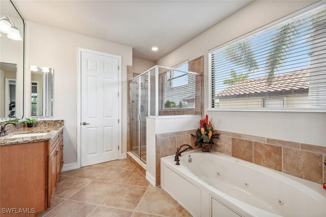 bathroom with vanity, tile patterned floors, and plus walk in shower