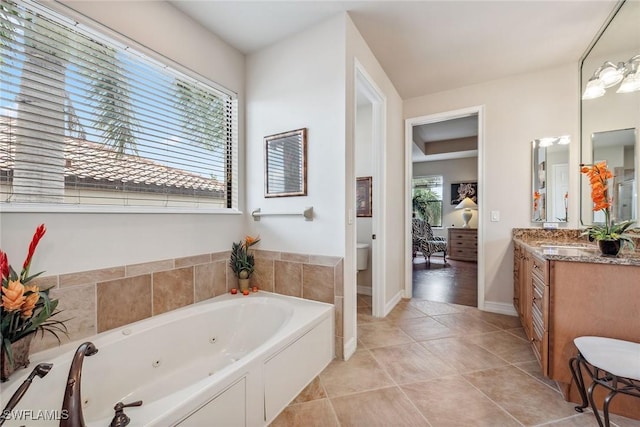 bathroom with toilet, tile patterned flooring, a bath, and vanity