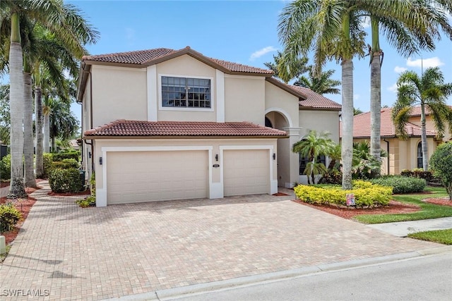 mediterranean / spanish-style house with a garage