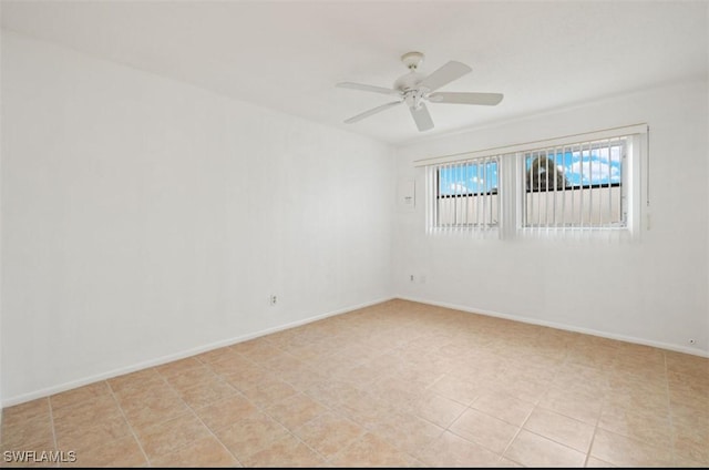 empty room with light tile patterned flooring and ceiling fan