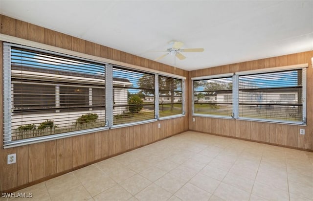 unfurnished sunroom with ceiling fan