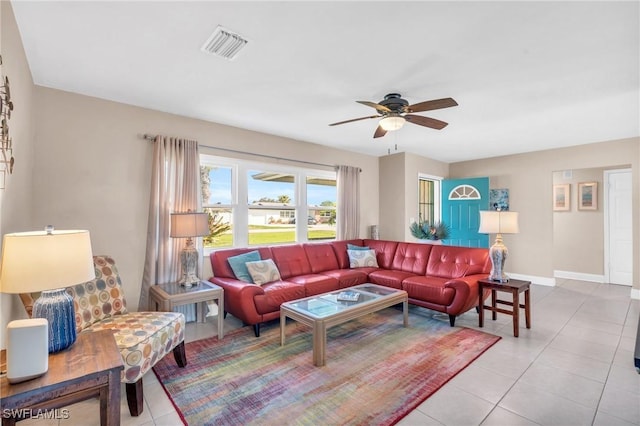 tiled living room with ceiling fan