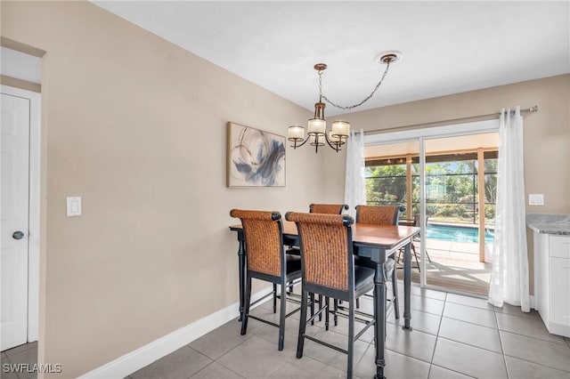 dining room with a notable chandelier and light tile patterned floors