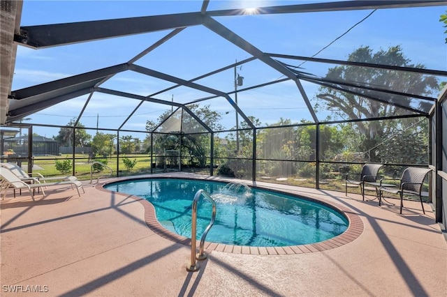 view of swimming pool featuring a lanai, pool water feature, and a patio