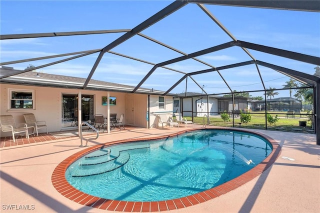 view of swimming pool featuring a lanai and a patio area