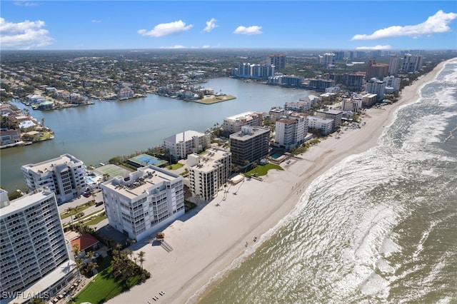 drone / aerial view with a water view and a beach view