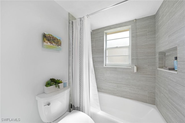 bathroom with shower / tub combo with curtain and toilet