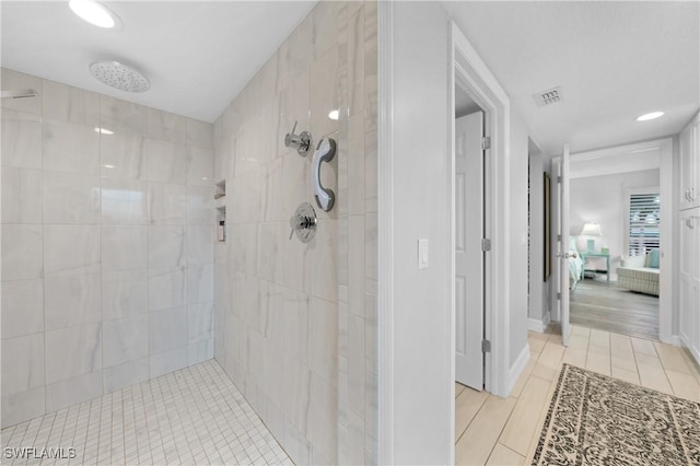 bathroom featuring tiled shower and hardwood / wood-style floors