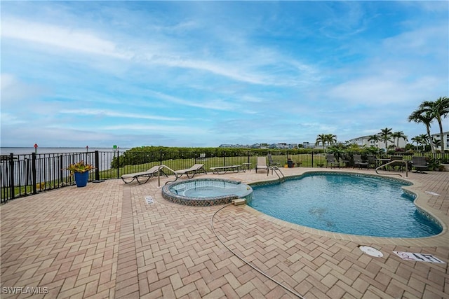 view of pool with a patio and a hot tub