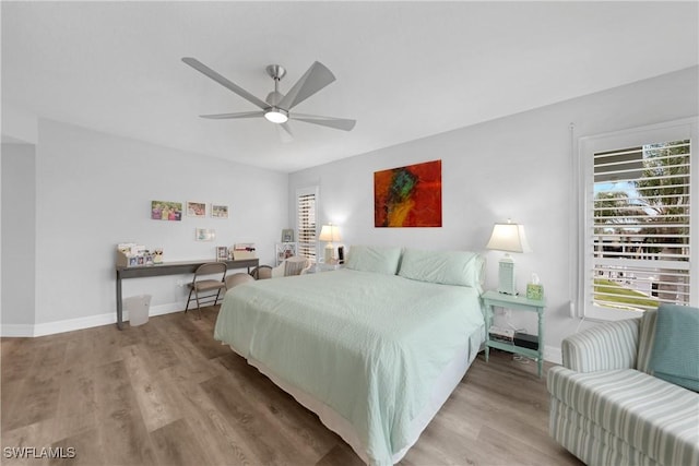 bedroom with ceiling fan and hardwood / wood-style floors