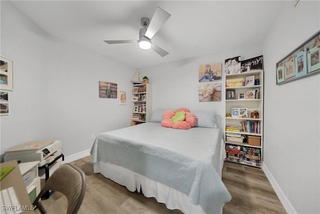 bedroom with ceiling fan and wood-type flooring