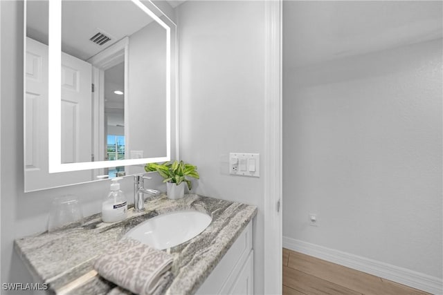 bathroom with hardwood / wood-style floors and vanity