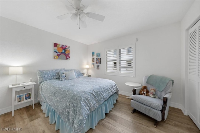 bedroom with a closet, ceiling fan, and hardwood / wood-style flooring