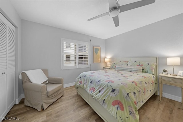 bedroom with ceiling fan, light hardwood / wood-style floors, and a closet