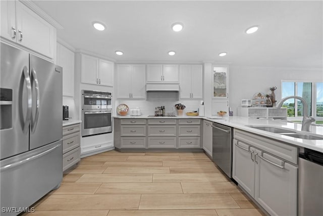 kitchen featuring gray cabinetry, white cabinets, sink, appliances with stainless steel finishes, and tasteful backsplash