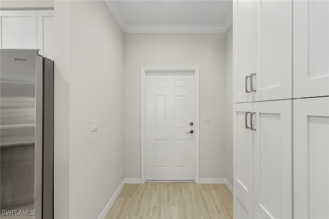 doorway with light hardwood / wood-style flooring and ornamental molding