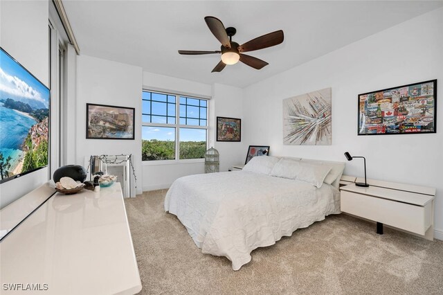 carpeted bedroom with a closet and ceiling fan