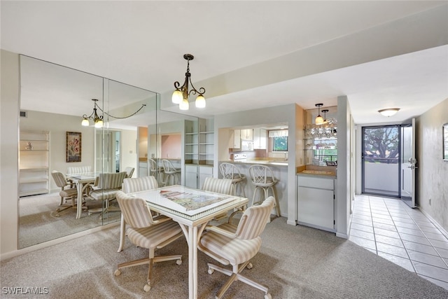 dining area featuring light carpet and an inviting chandelier