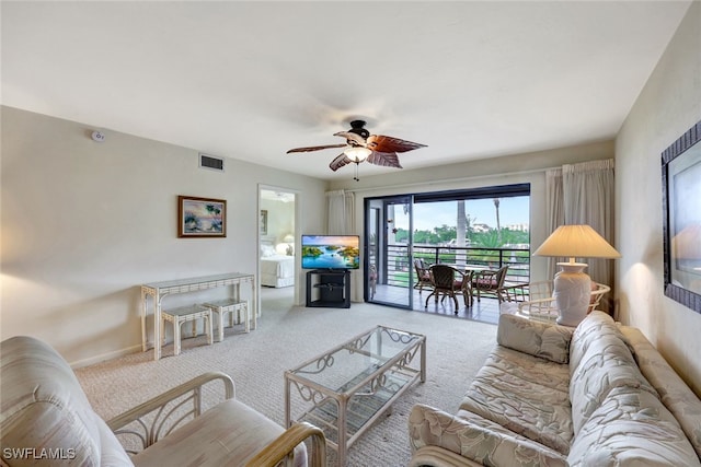 carpeted living room with ceiling fan