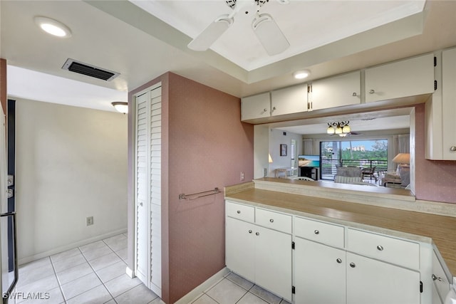 kitchen featuring white cabinets, light tile patterned floors, and ceiling fan