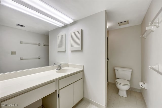 bathroom featuring toilet, vanity, and an enclosed shower