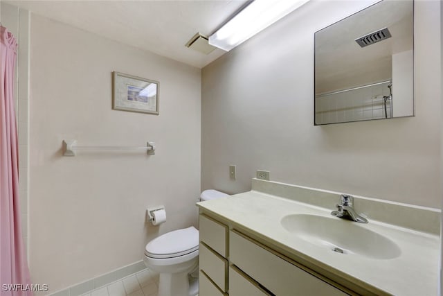 bathroom featuring toilet, vanity, a shower with shower curtain, and tile patterned flooring