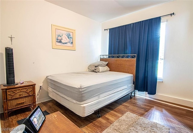 bedroom featuring dark wood-type flooring