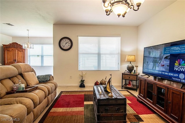 living room with a chandelier and light tile patterned floors