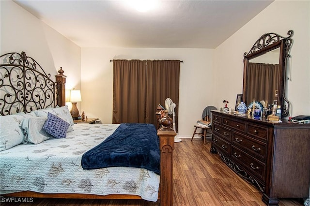 bedroom with hardwood / wood-style flooring