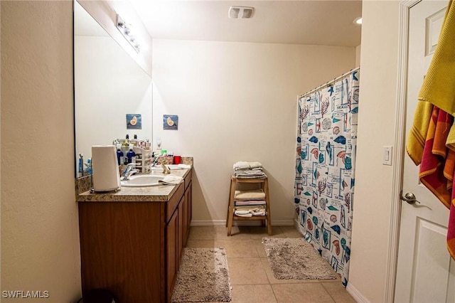 bathroom featuring tile patterned flooring, vanity, and curtained shower