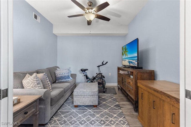 living room with dark hardwood / wood-style floors and ceiling fan