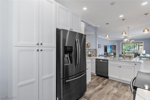 kitchen with stainless steel refrigerator with ice dispenser, ceiling fan, black dishwasher, white cabinetry, and hanging light fixtures