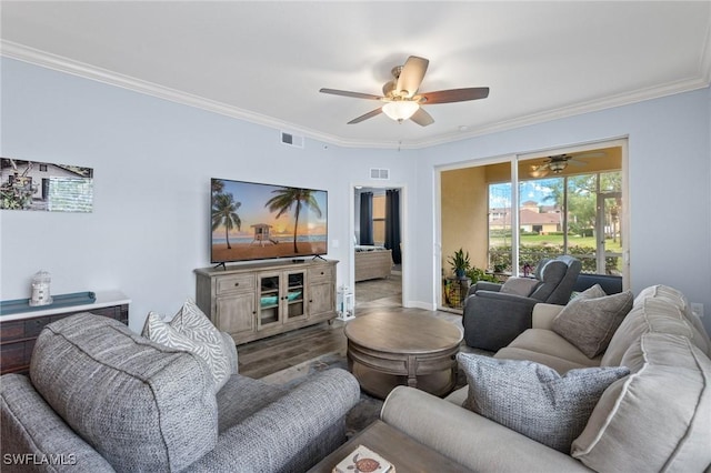 living room featuring ceiling fan, wood-type flooring, and crown molding