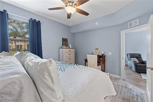 bedroom with light hardwood / wood-style floors and ceiling fan