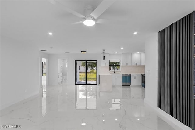 unfurnished living room with ceiling fan and sink