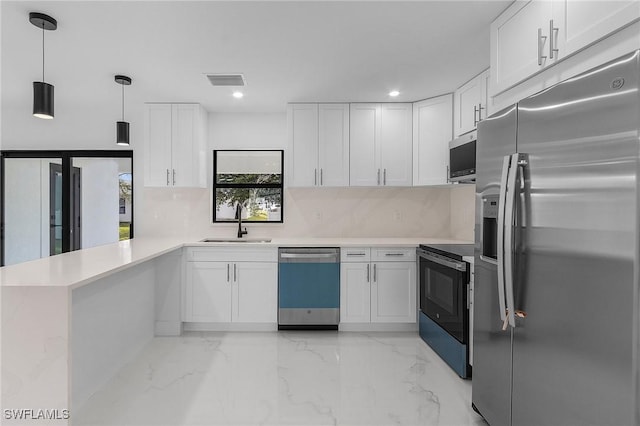 kitchen featuring white cabinets, stainless steel appliances, and kitchen peninsula