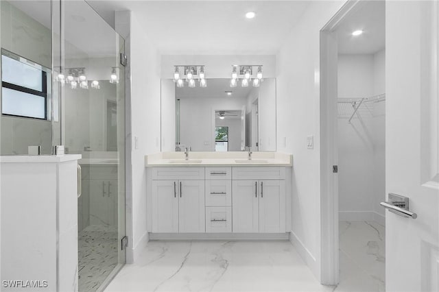 bathroom featuring ceiling fan, a shower with shower door, a healthy amount of sunlight, and vanity