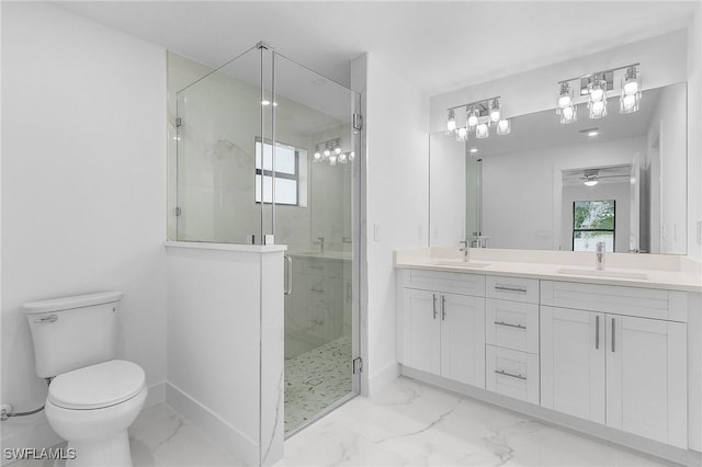 bathroom featuring ceiling fan, vanity, a shower with shower door, and toilet