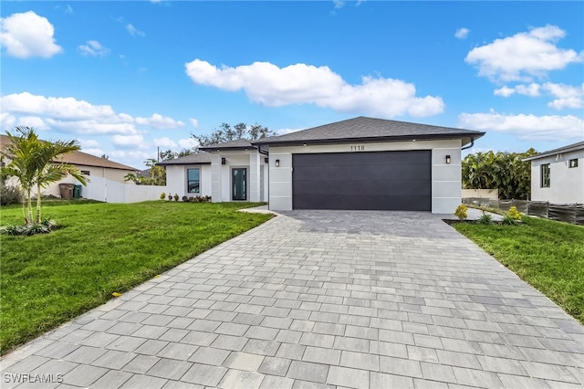 view of front facade featuring a front yard and a garage