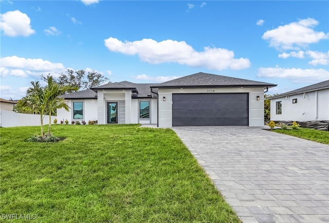 view of front of property featuring a garage and a front lawn