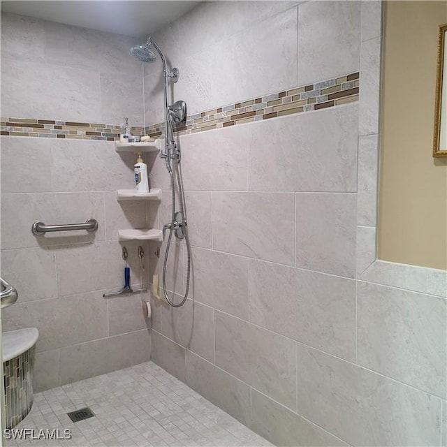 bathroom with tiled shower