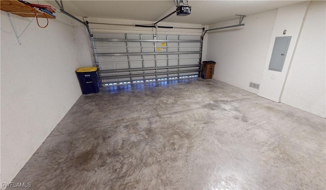 garage featuring electric panel and a garage door opener